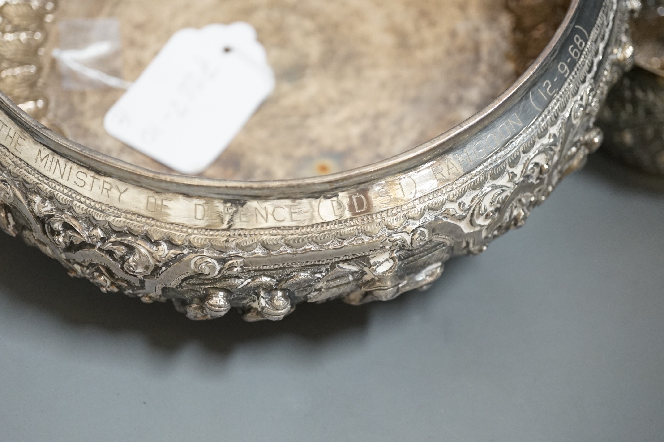 An Indian repousse white metal presentation bowl, with engraved inscription, diameter 21.5cm and a similar smaller bowl